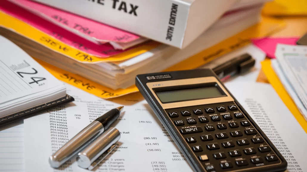 Tax calculator with financial documents and pens